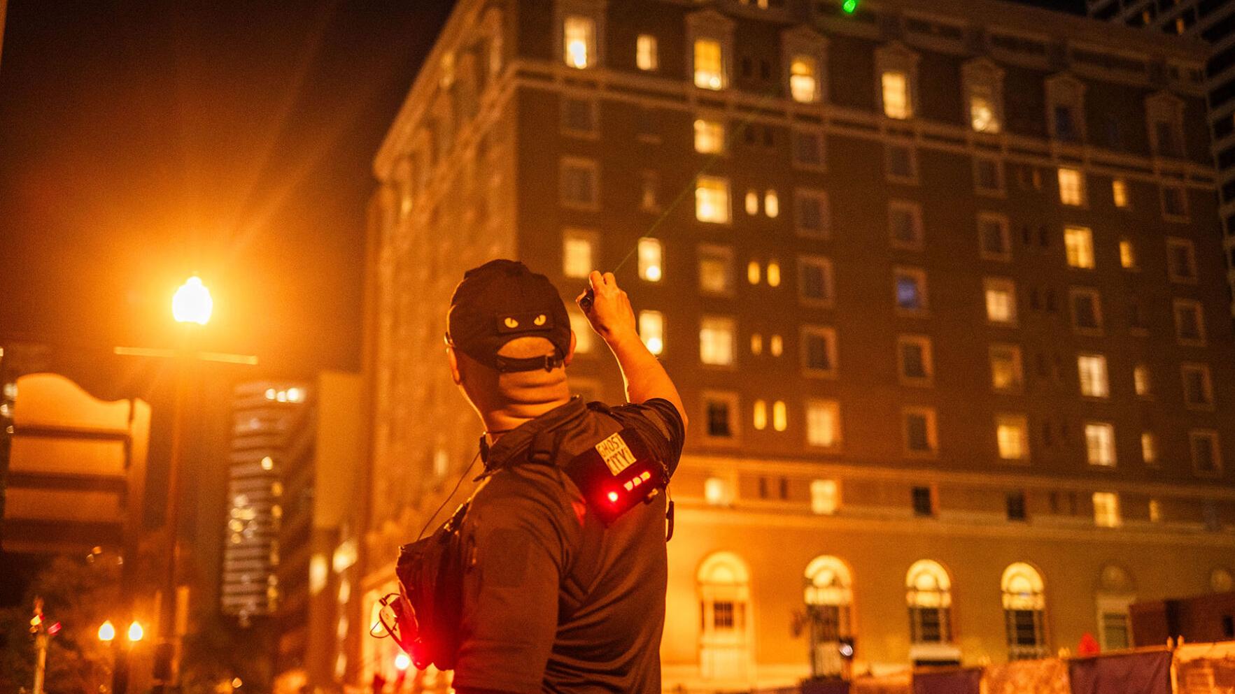 Nestor Ilagan indicates a window with a laser pointer